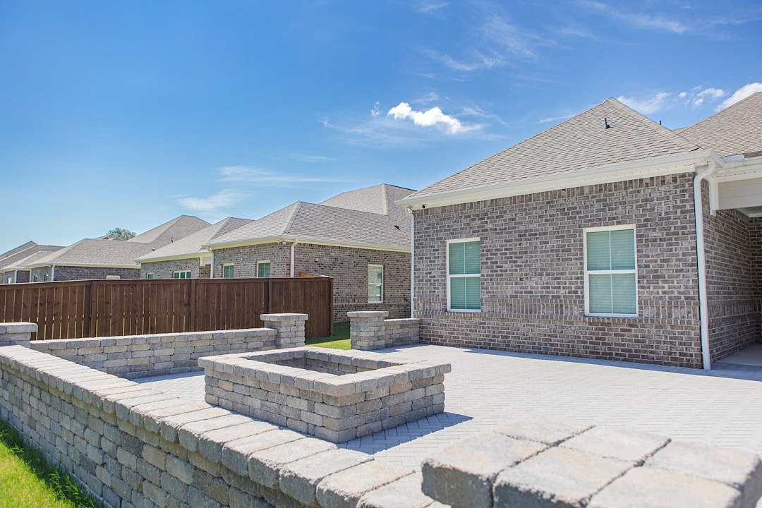 Sculpted Comfort: Large Paver Patio with Fire Pit and Custom Seating Walls